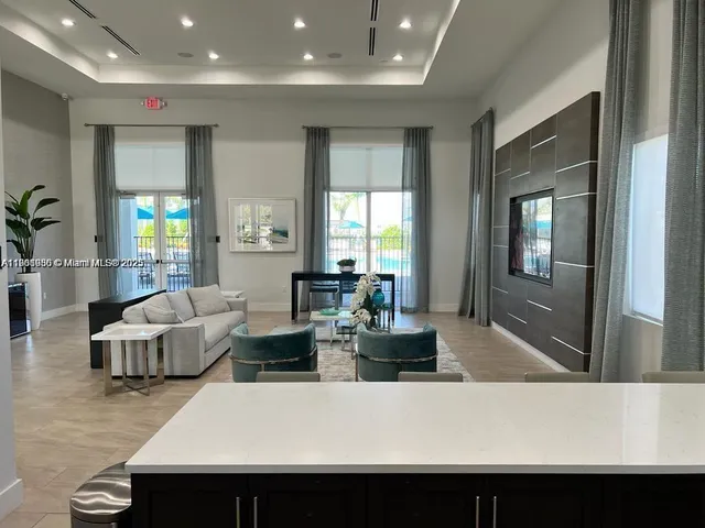 a living room with fireplace furniture and a potted plant