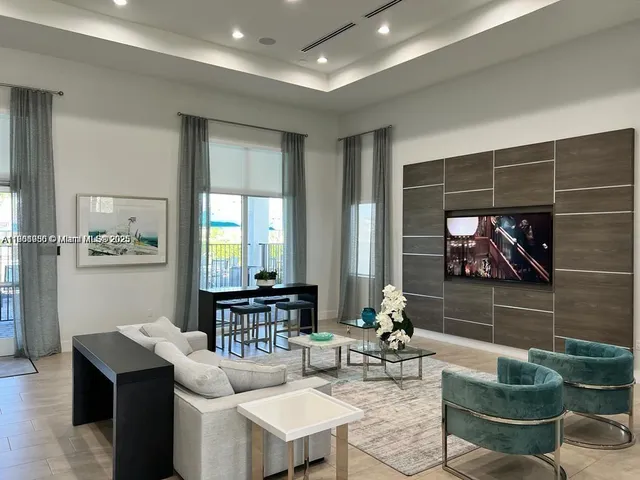 a living room with fireplace furniture and a potted plant