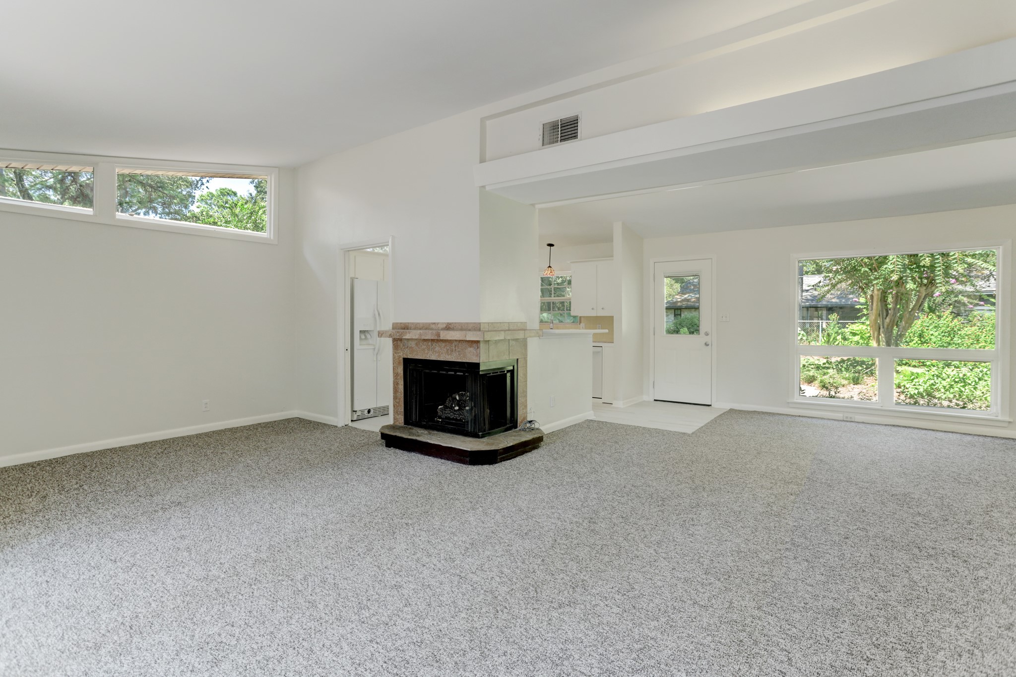10226 Ivyridge Road Houston, TX 77043 - Photo 10 of 37 an empty room with windows and fireplace