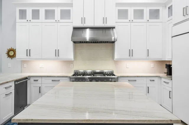 a large kitchen with a table and chairs