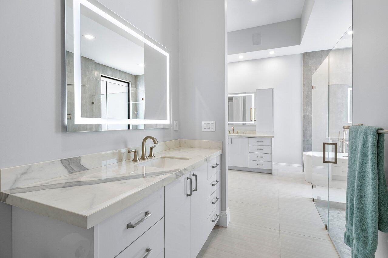 17607 Bocaire Place Boca Raton, FL 33487 - Photo 25 of 62 a bathroom with a double vanity sink and mirror