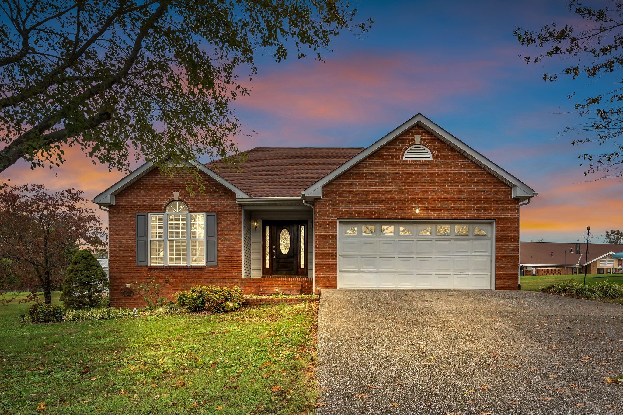 a front view of a house with a yard and garage