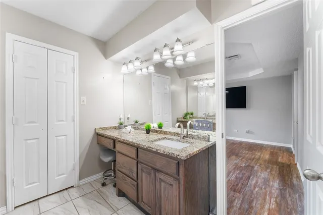 a bathroom with a sink a mirror and vanity