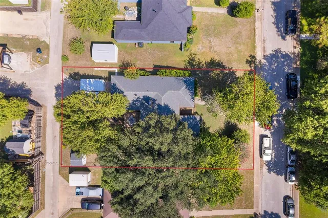 aerial view of a house with a yard and garden