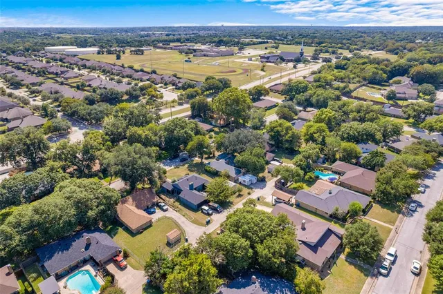 an aerial view of residential houses with outdoor space