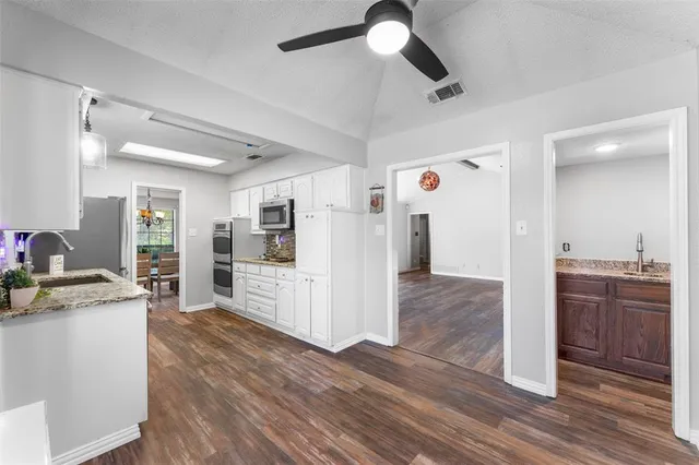 a view of kitchen with cabinets and stainless steel appliances