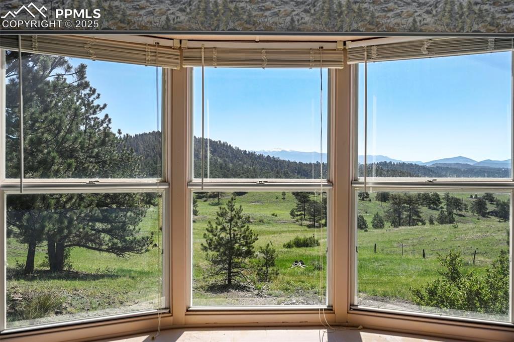 332 Valley Circle Guffey, CO 80820 - Photo 12 of 32 a view of a room that has a large window and a lake