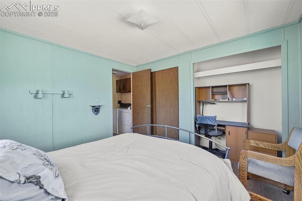 332 Valley Circle Guffey, CO 80820 - Photo 23 of 32 a bedroom with a bed and a dresser in it