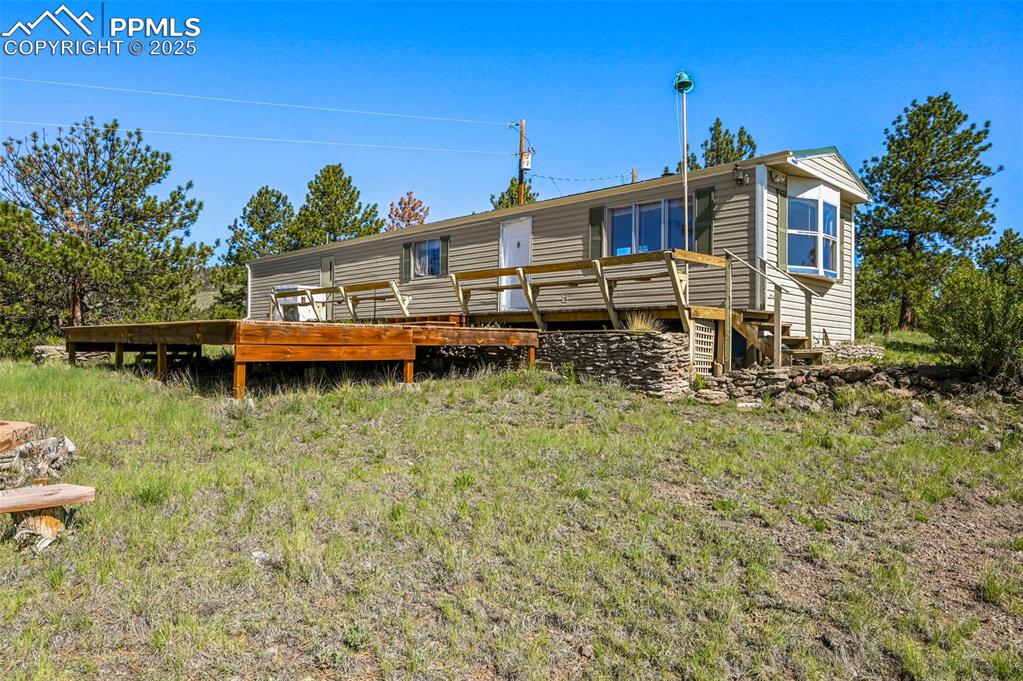 332 Valley Circle Guffey, CO 80820 - Photo 5 of 32 a front view of a house with a yard