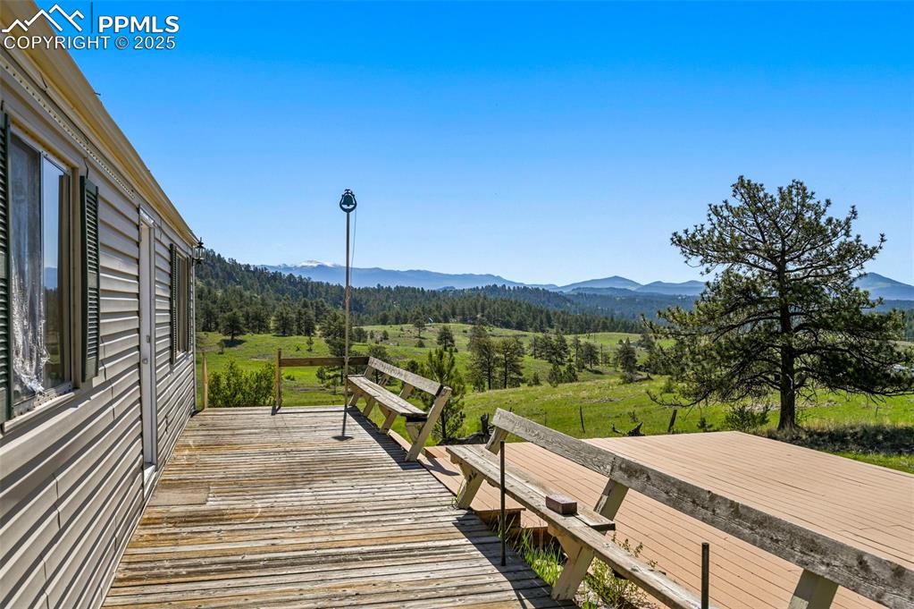 332 Valley Circle Guffey, CO 80820 - Photo 6 of 32 a view of a wooden deck with a yard