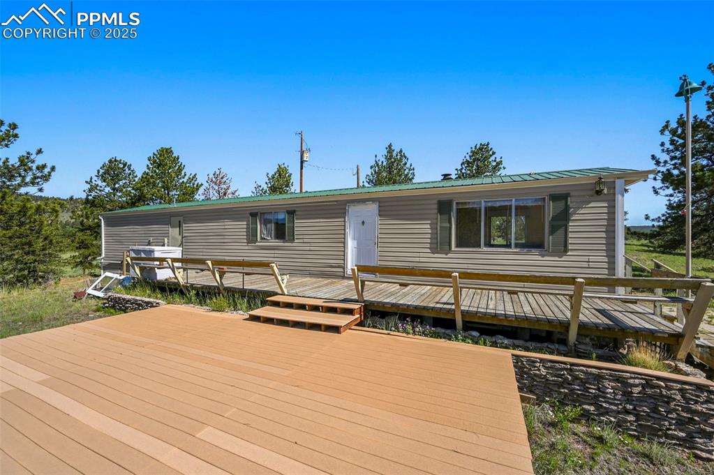 332 Valley Circle Guffey, CO 80820 - Photo 9 of 32 a view of a house with wooden deck and furniture
