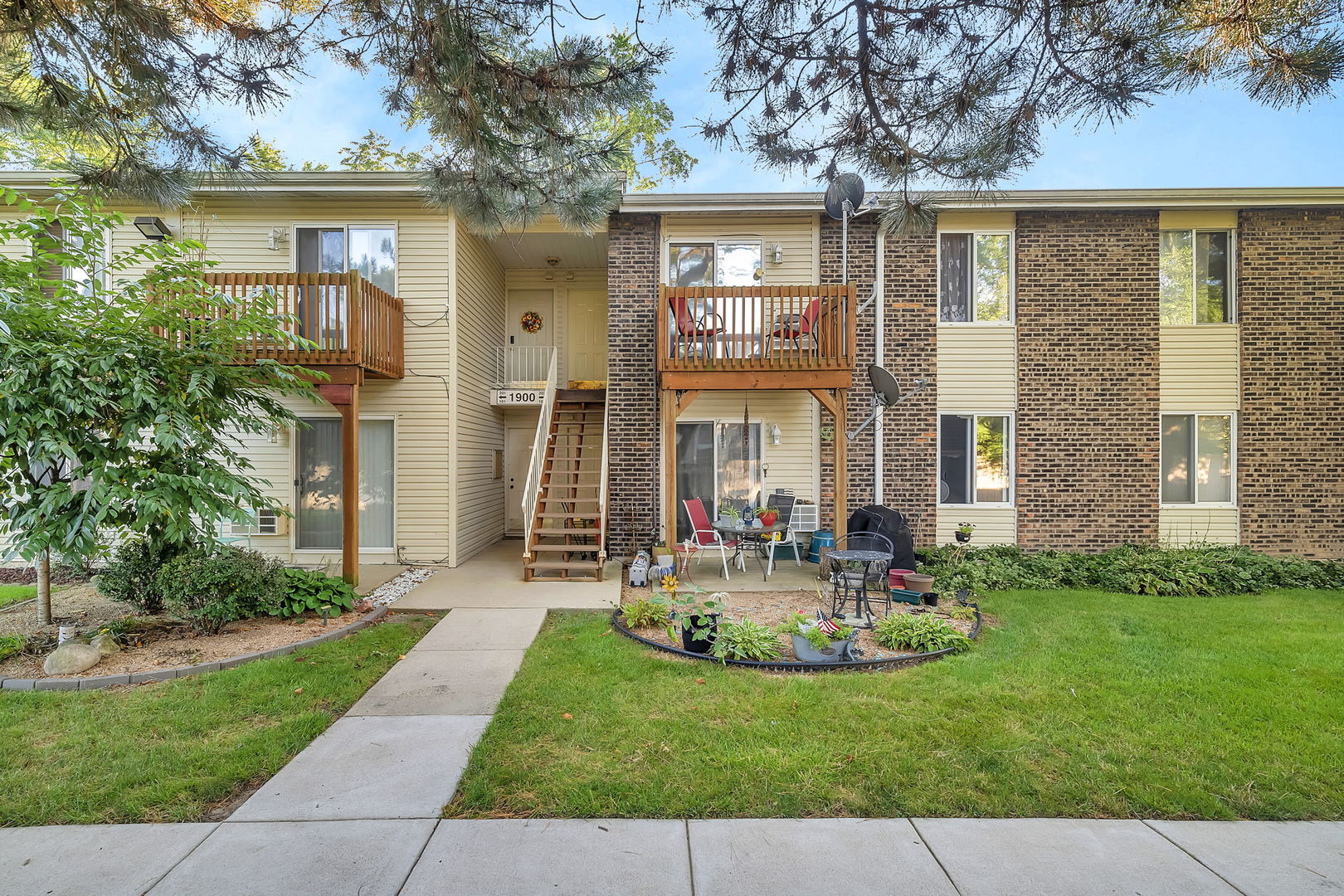 1900 Light Road, Unit 202 Oswego, IL 60543 - Photo 1 of 15 front view of a house with a yard