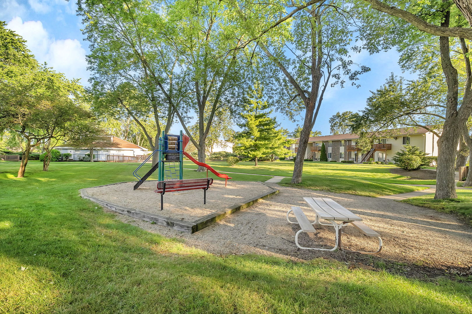 1900 Light Road, Unit 202 Oswego, IL 60543 - Photo 14 of 15 a park view with a bench and a large tree