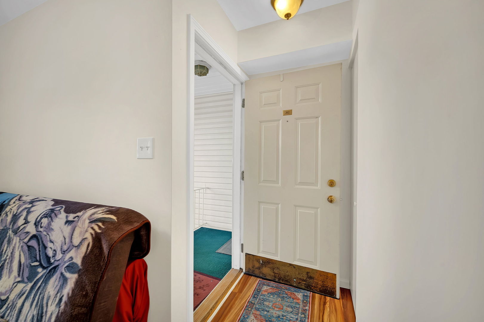 1900 Light Road, Unit 202 Oswego, IL 60543 - Photo 2 of 15 a view of walk in closet with clothes and shoes