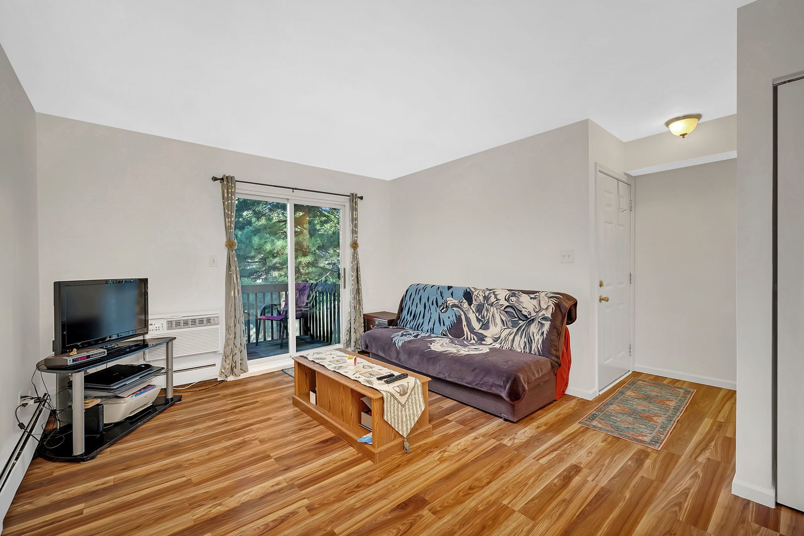 1900 Light Road, Unit 202 Oswego, IL 60543 - Photo 3 of 15 a living room with furniture and a flat screen tv
