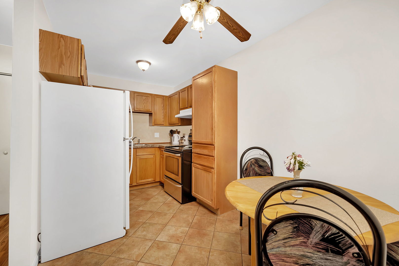 1900 Light Road, Unit 202 Oswego, IL 60543 - Photo 4 of 15 a bedroom with a bed and a stove