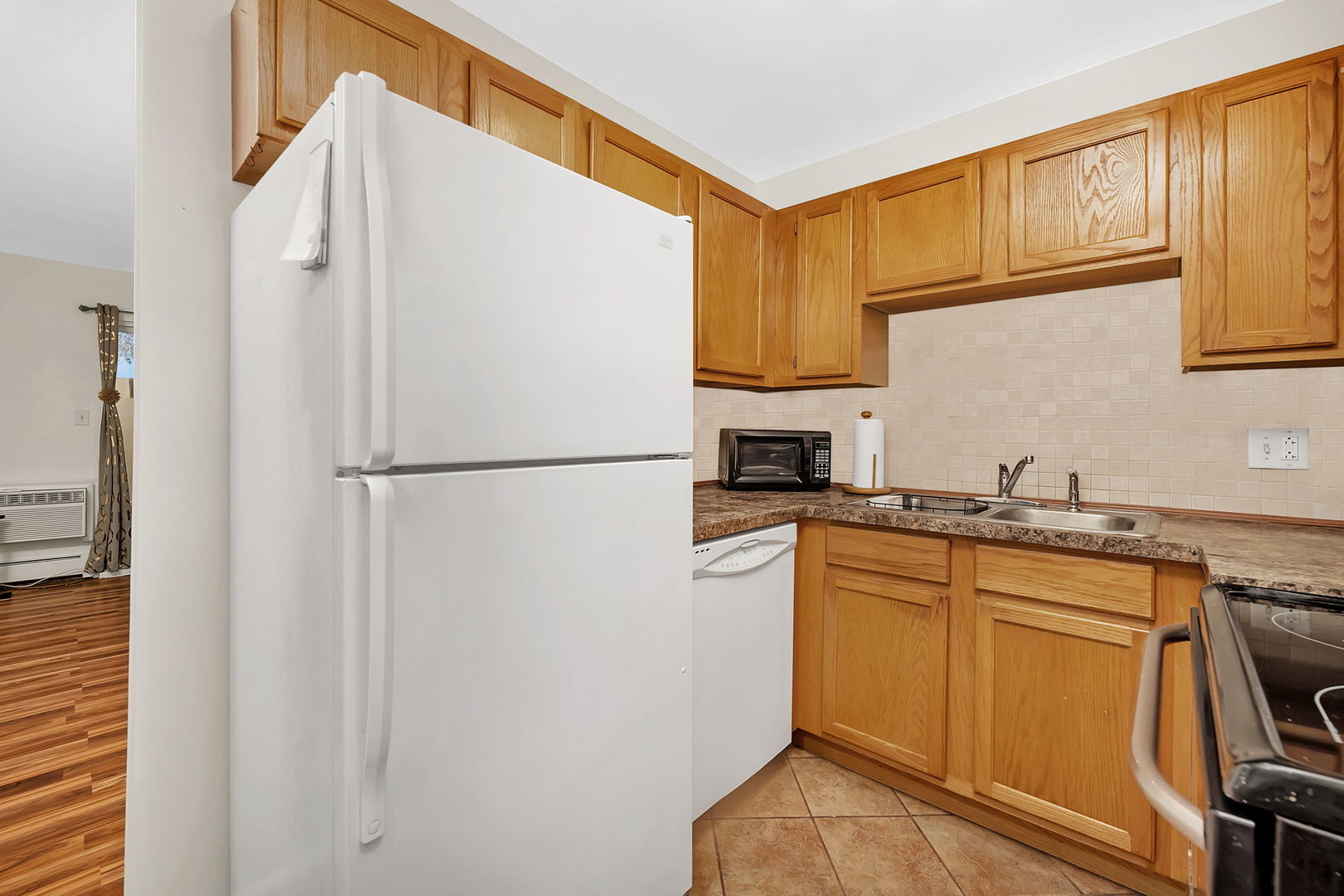 1900 Light Road, Unit 202 Oswego, IL 60543 - Photo 5 of 15 a kitchen with stainless steel appliances a refrigerator sink and cabinets