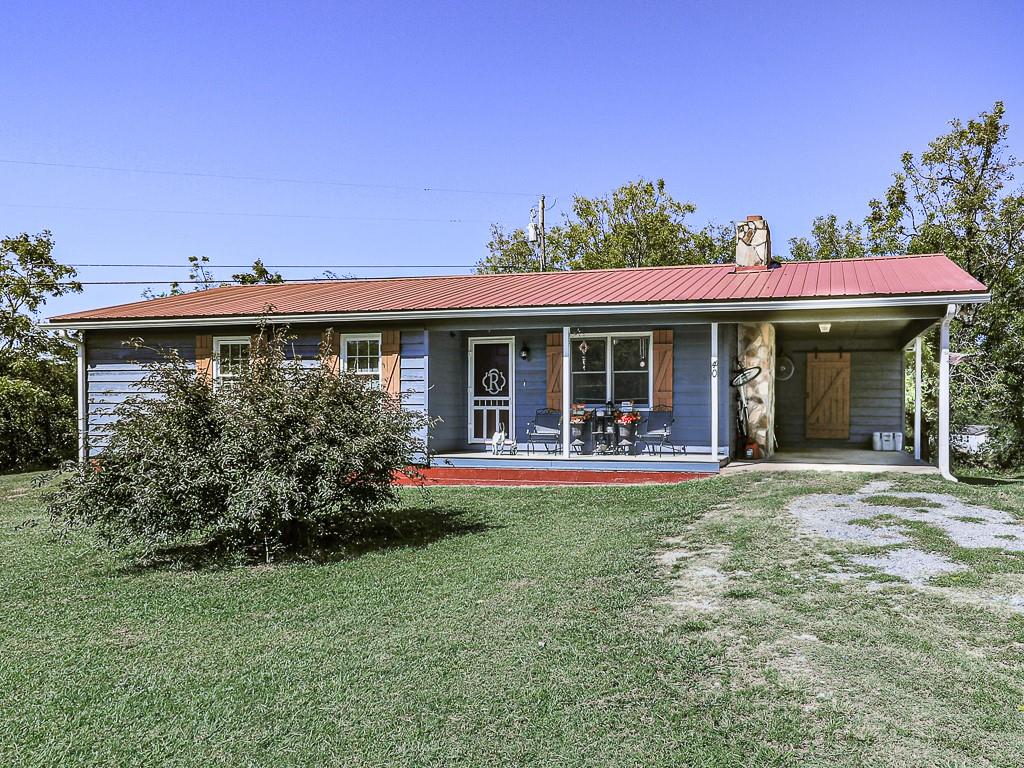 40 Townsend Road Talking Rock, GA 30175 - Photo 1 of 1 a view of a house with table and chairs next to a yard