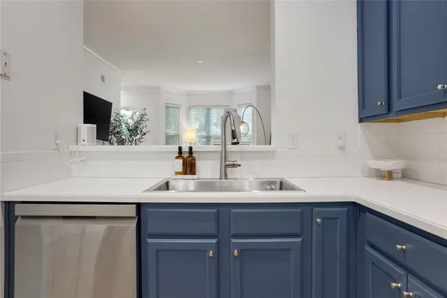 a kitchen with a sink and a refrigerator