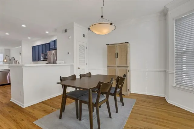 a view of a dining room with furniture and wooden floor