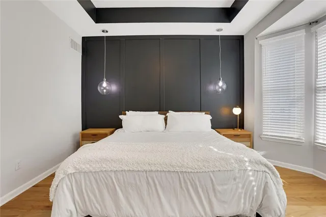 a bedroom with a bed and a mirror