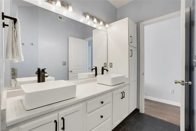 a bathroom with a double vanity sink mirror and