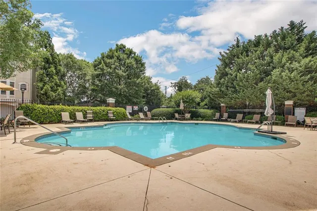 a view of a swimming pool with a yard