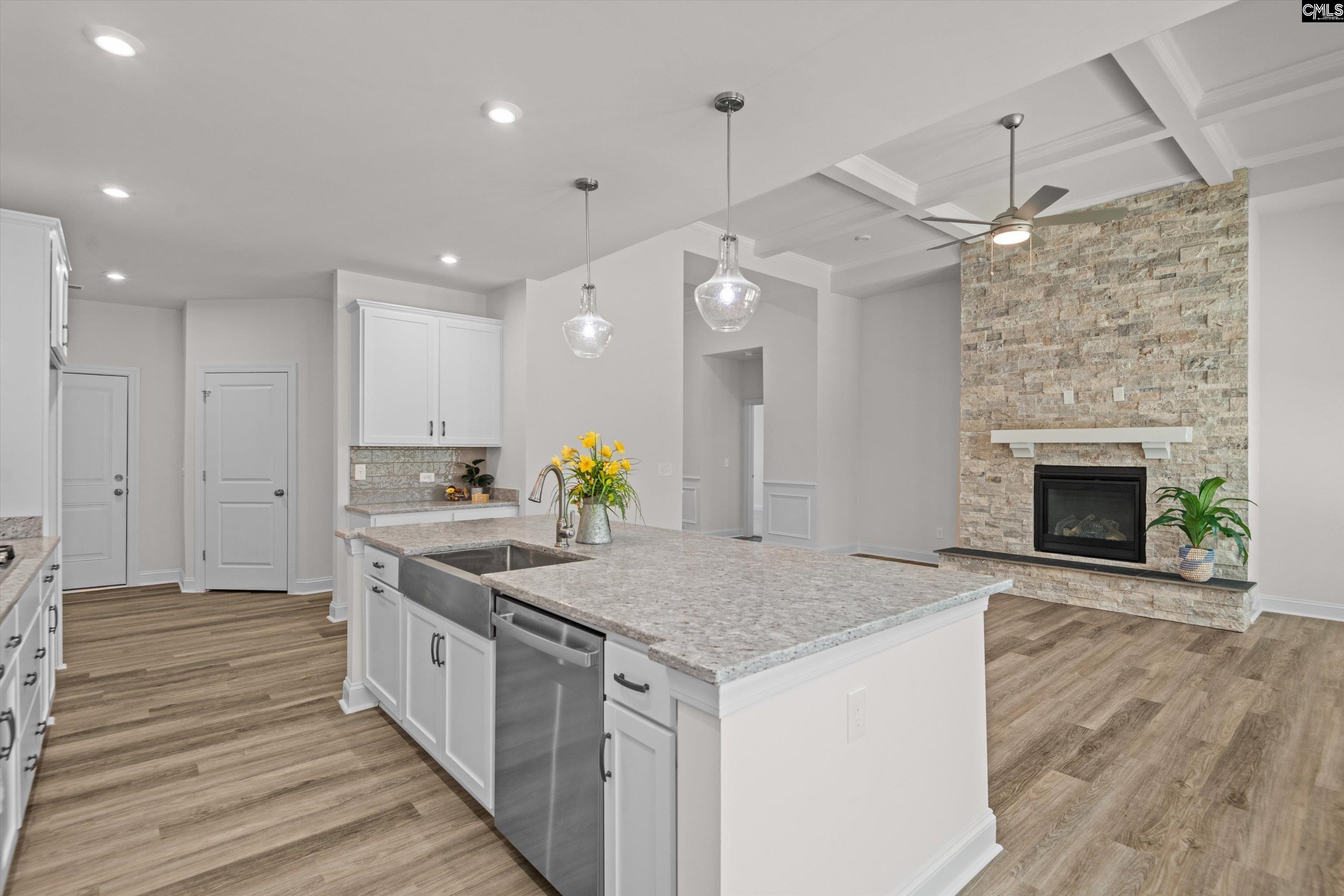 558 Wild Ginger Loop Irmo, SC 29063 - Photo 16 of 42 a kitchen with stainless steel appliances granite countertop a kitchen island a stove and a wooden floors