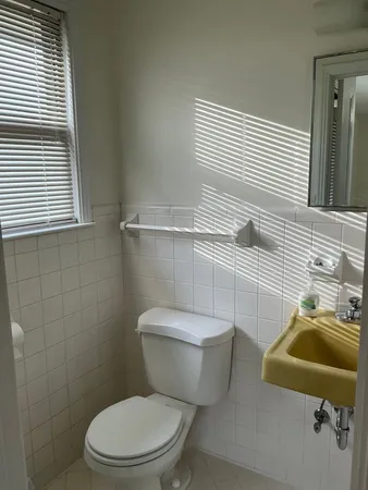a white toilet sitting next to a bathroom sink