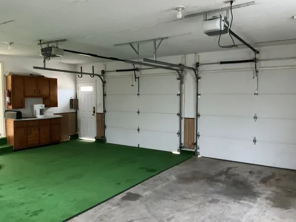 a view of a kitchen with a fridge and a window