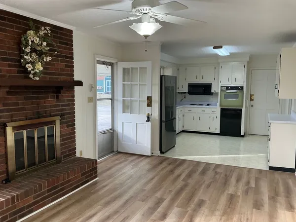 a kitchen with a refrigerator and a stove top oven