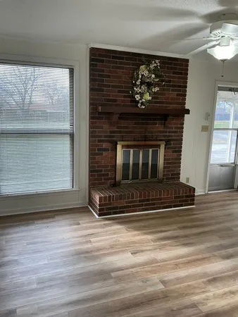 a living room with a fireplace and a fireplace
