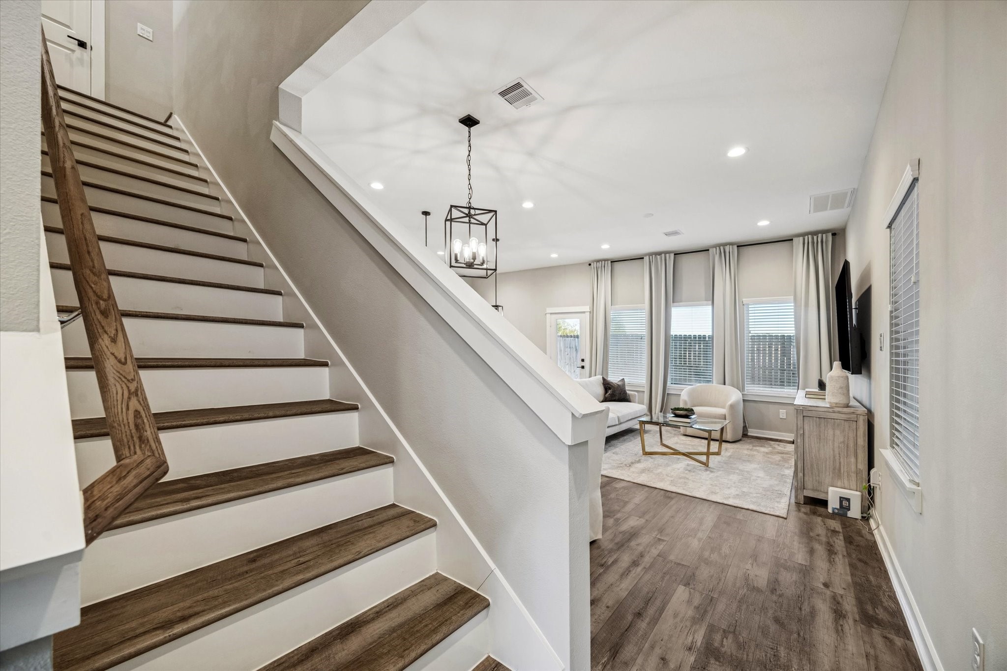 11307 Stonework Grove Lane Houston, TX 77076 - Photo 20 of 46 a view of staircase and living room with wooden floor