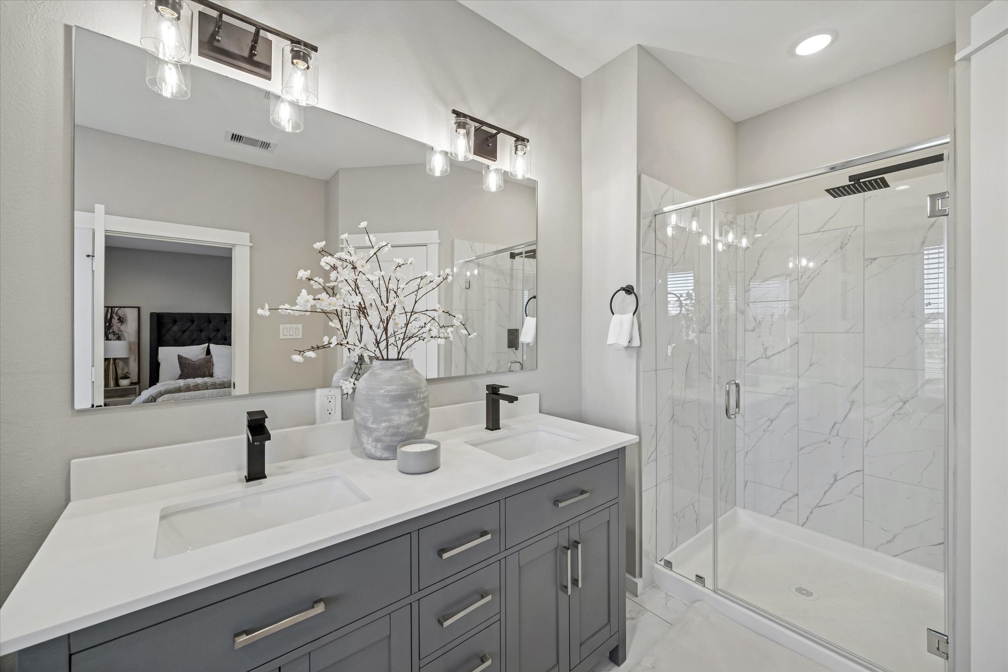 11307 Stonework Grove Lane Houston, TX 77076 - Photo 25 of 46 a bathroom with a double vanity sink mirror and shower