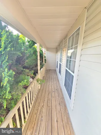 a view of balcony with wooden floor