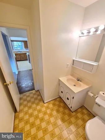 a bathroom with a sink toilet and mirror