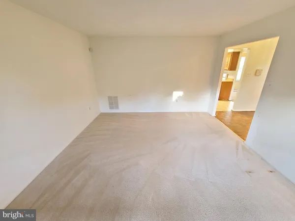 a view of a big room with closet and mirror in it