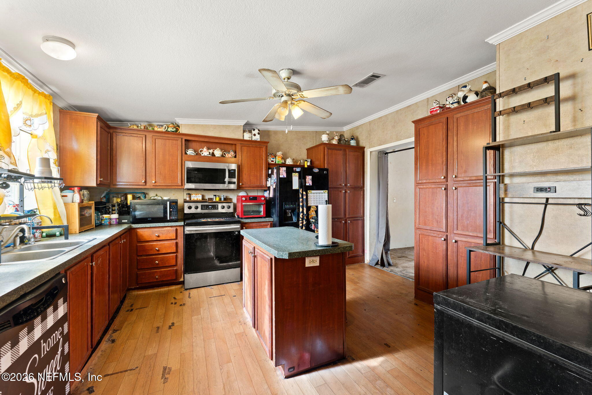 4170 Falcon Run Lane Middleburg, FL 32068 - Photo 5 of 13 a kitchen with stainless steel appliances granite countertop a refrigerator a stove top oven a sink dishwasher and wooden cabinets