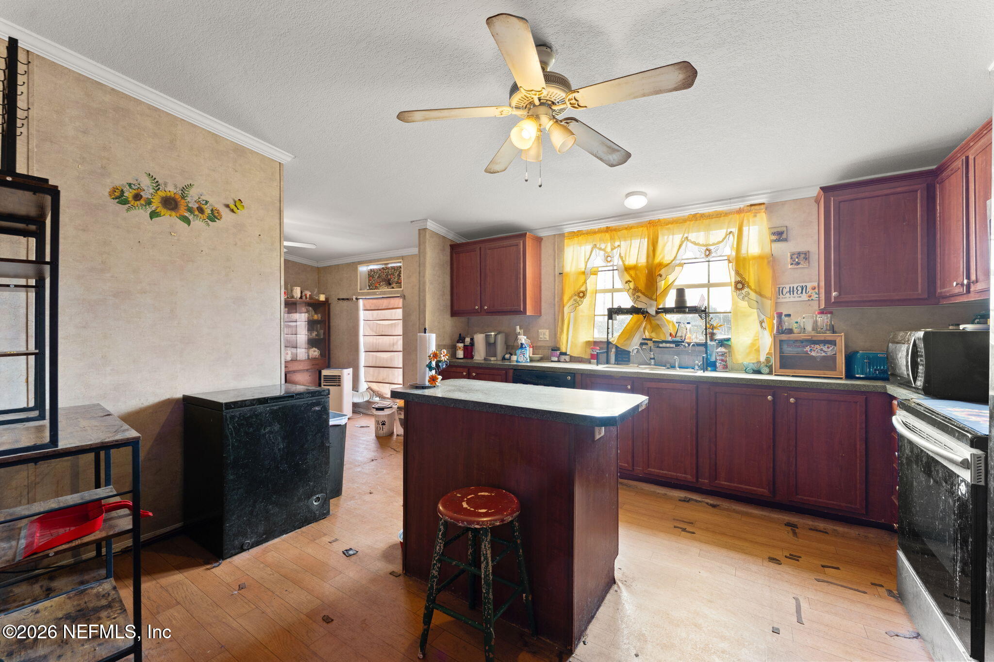 4170 Falcon Run Lane Middleburg, FL 32068 - Photo 6 of 13 a kitchen with stainless steel appliances granite countertop a sink dishwasher stove and refrigerator with wooden floor