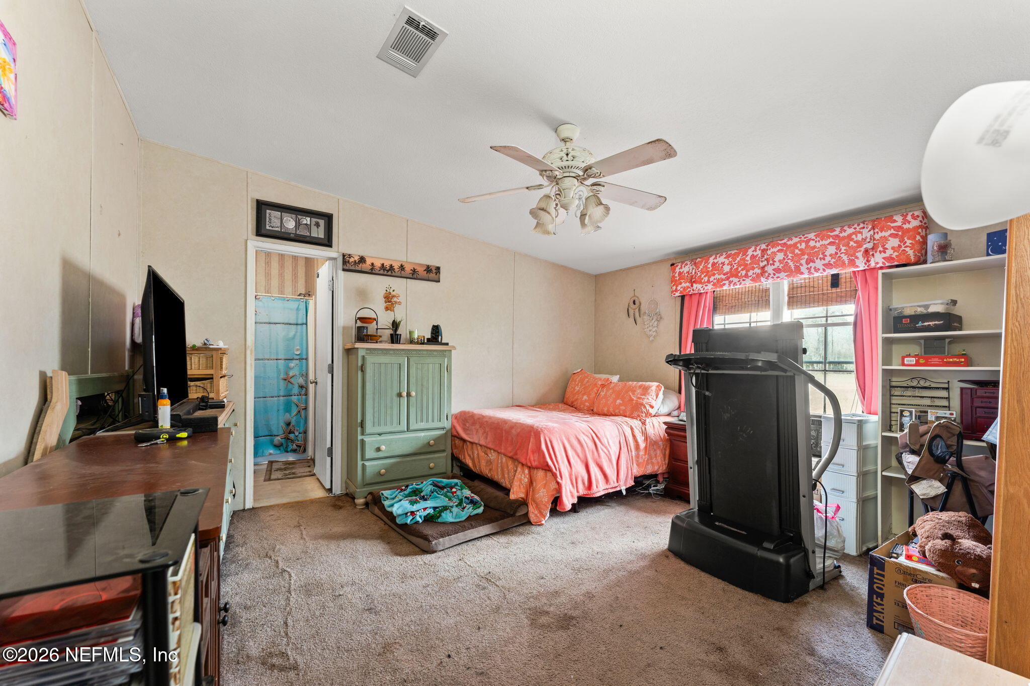 4170 Falcon Run Lane Middleburg, FL 32068 - Photo 7 of 13 a living room with furniture a flat screen tv and a refrigerator
