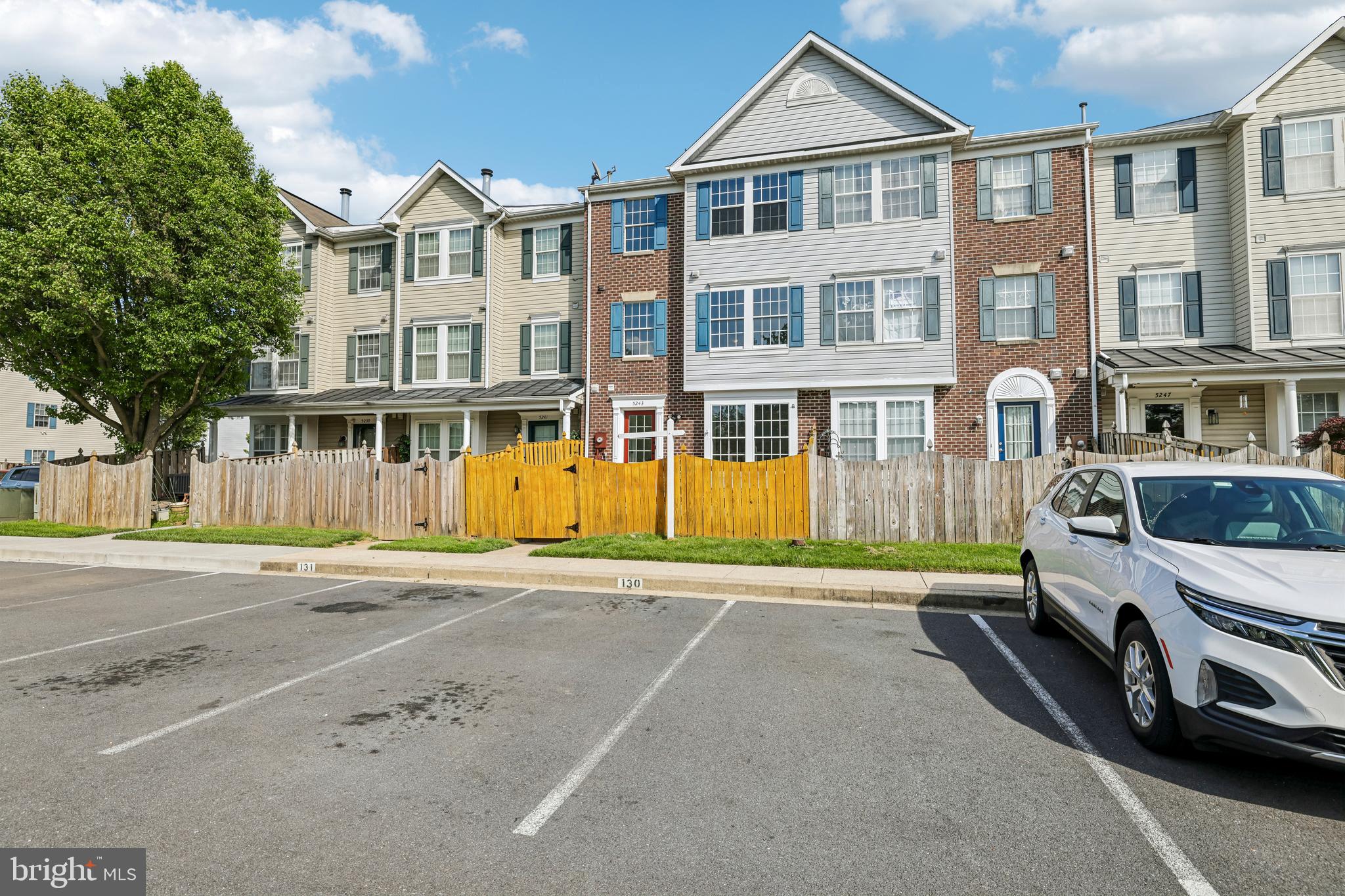 5243 Regal Court Frederick, MD 21703 - Photo 24 of 27 a view of a big house with a large windows and a car parked on the road