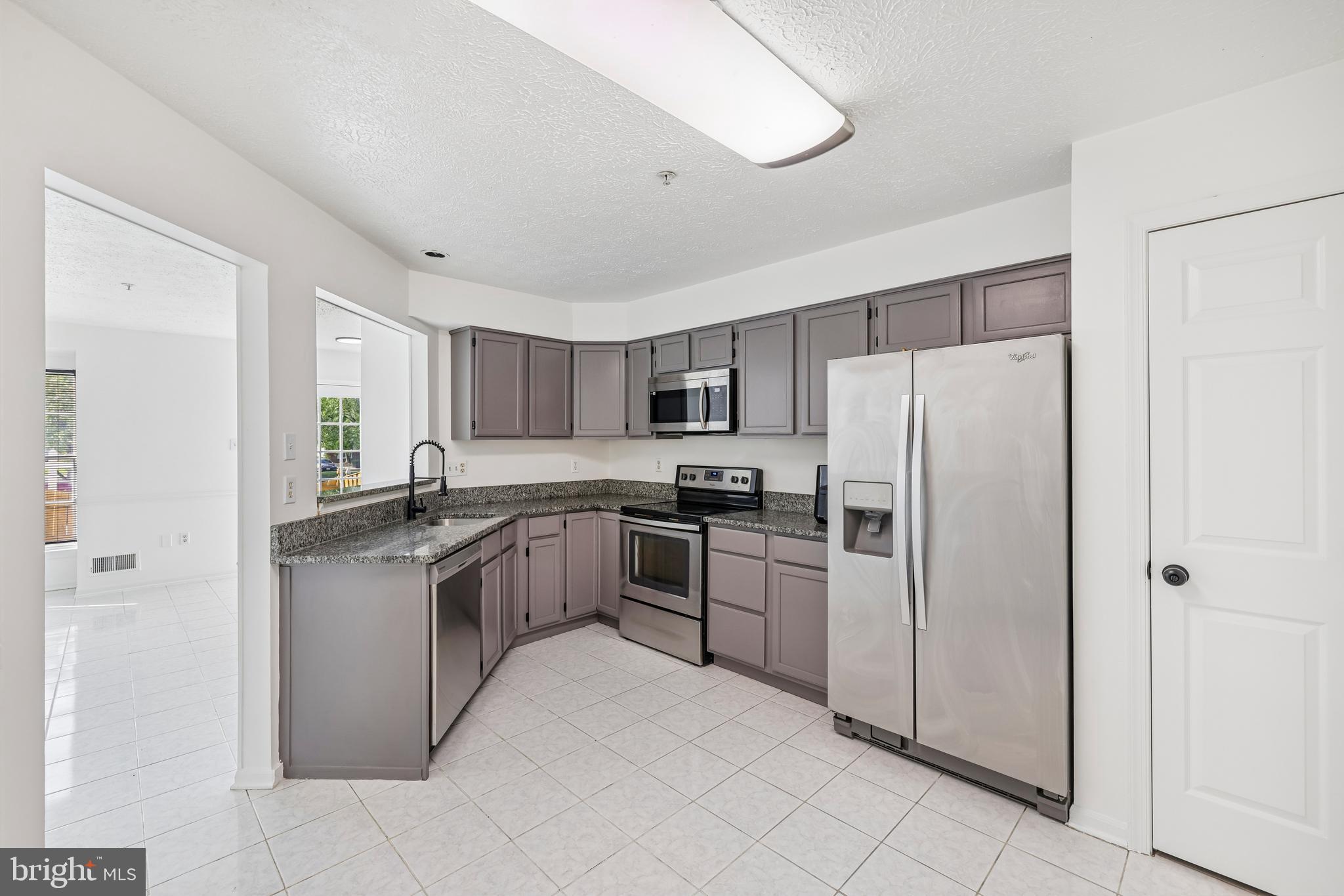 5243 Regal Court Frederick, MD 21703 - Photo 4 of 27 a kitchen with stainless steel appliances granite countertop a refrigerator sink and stove