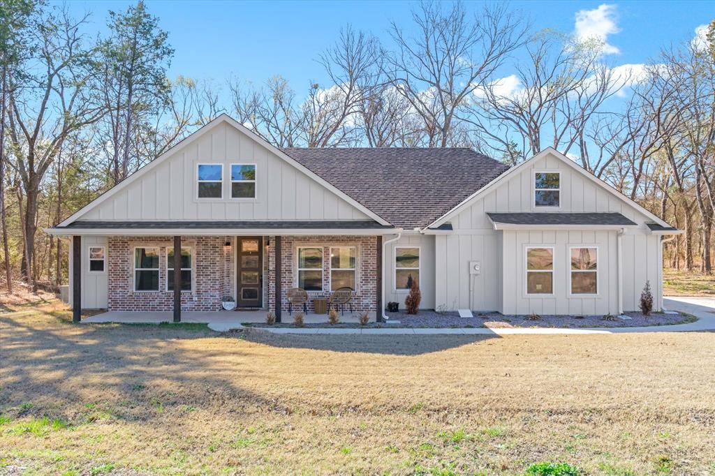 1159 Highway 276 Emory, TX 75440 - Photo 1 of 39 a front view of a house with a yard and large tree