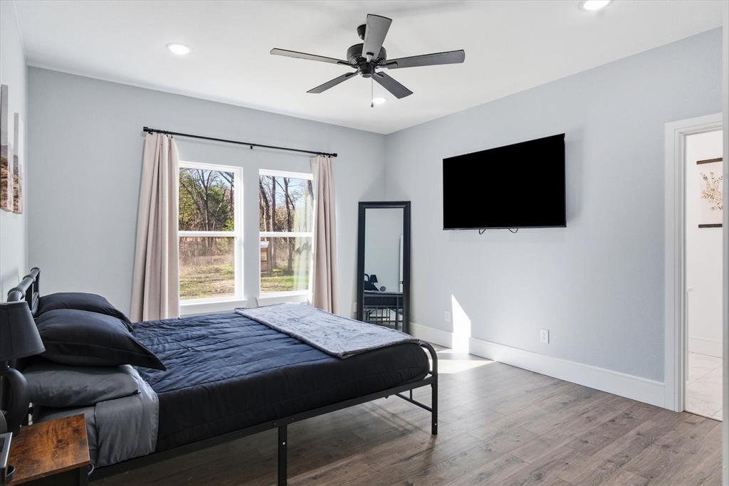 1159 Highway 276 Emory, TX 75440 - Photo 14 of 39 a spacious bedroom with a bed and a flat screen tv