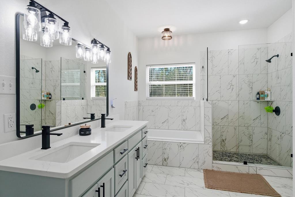 1159 Highway 276 Emory, TX 75440 - Photo 17 of 39 a bathroom with a tub sink and mirror