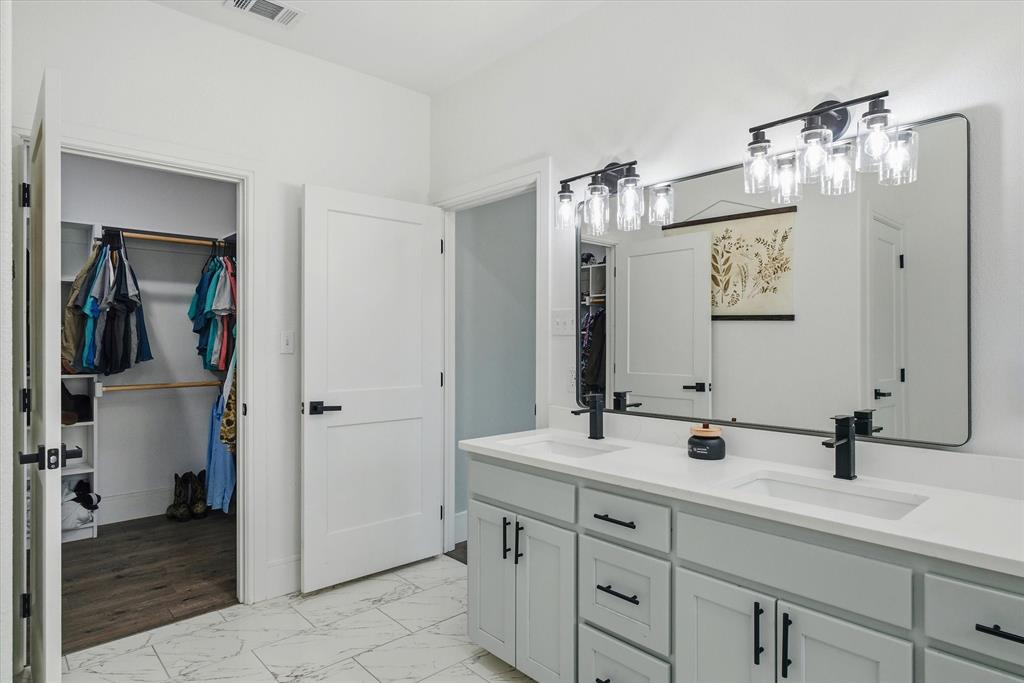 1159 Highway 276 Emory, TX 75440 - Photo 18 of 39 a bathroom with a double vanity sink and a mirror