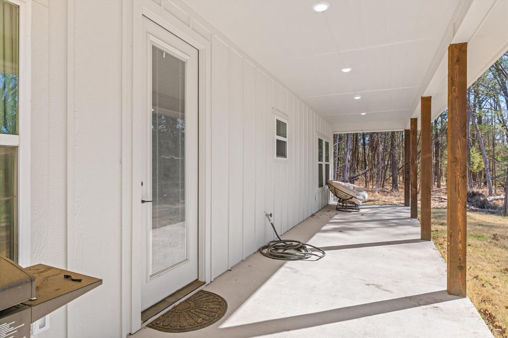 1159 Highway 276 Emory, TX 75440 - Photo 28 of 39 a view of a hallway with wooden floor and a fireplace