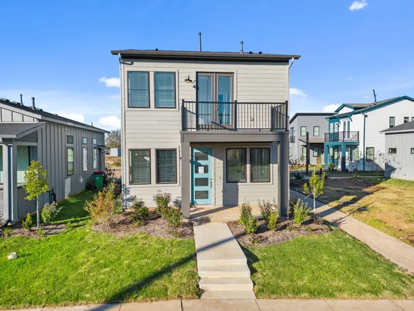 a front view of a house with a yard table and chairs