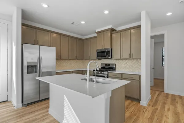 a kitchen with wooden cabinets and a stove top oven