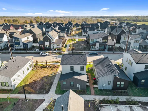 a view of a livingroom with wooden floor and a ceiling fan